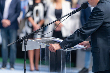 Fair's lively atmosphere, a compelling male speaker addresses a captivated audience during a...