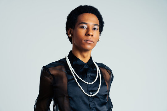 Fashionable homosexual man posing in studio - Fluid gender non binary hispanic  man posing in studio with fashionable clothing - concepts about LGBTQ, genderless and diversity