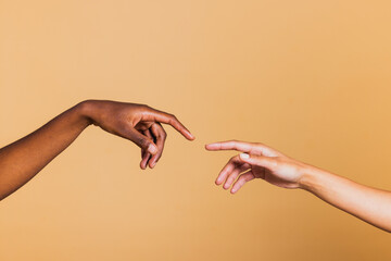 Close up of two female hands together on brown background. Hands of two african american women.