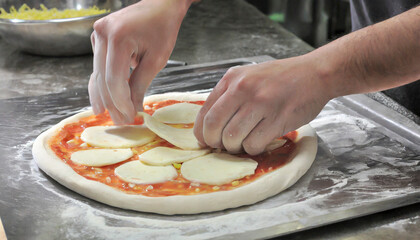 Hands making a pizza
