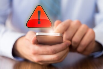 People hands with warning message icon on phone