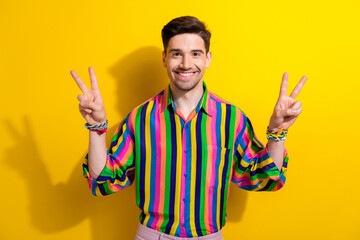 Photo of funky guy lgbt fan supporting peace in our world wearing striped trendy shirt isolated on yellow bright color background