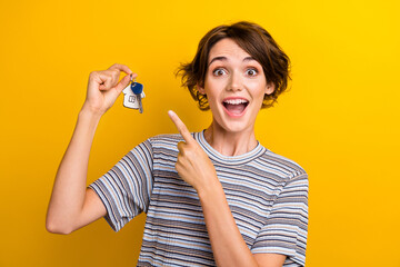 Photo of excited cheerful cute girl dressed trendy clothes demonstrate keys purchase property...