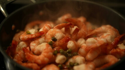 Seafood shrimps inside pan with smoke steam, adding ingredients on top of food preparation