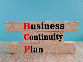 Business Continuity Plan symbol. On a bright blue background brick blocks with the text BCP Business Continuity Plan. Manufacturing of wooden toys. - obrazy, fototapety, plakaty