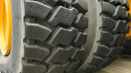 Close-up of tyre tread of the world's largest dump truck. Wheels of a large truck. Truck tyres.