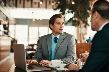 Focused Conversation Between Business Colleagues in a Cafe