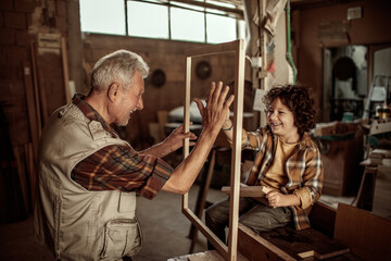 Grandfather and Grandson in a Woodshop