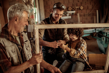 Multi generational family in the woodworking workshop