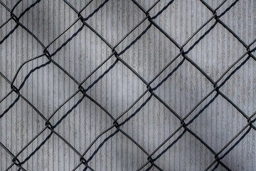 rhombide metal fence texture on brick