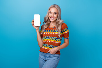 Photo of pretty adorable girl dressed print shirt showing modern device empty space isolated blue color background