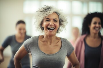 Middle-aged women find joy in Zumba, expressing their active lifestyle. Candid moments showcase the energetic camaraderie and shared passion for fitness and fun - obrazy, fototapety, plakaty