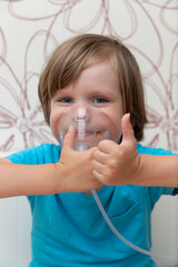 Blue-eyed boy being treated with nebulizer, child treating lungs, breathing medication