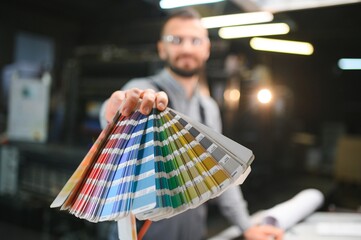 Printing house. The printer works in a modern production hall