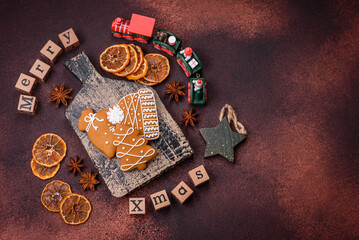 Beautiful delicious sweet winter Christmas gingerbread cookies on a bronze textured background