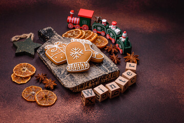 Beautiful delicious sweet winter Christmas gingerbread cookies on a bronze textured background