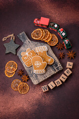 Beautiful delicious sweet winter Christmas gingerbread cookies on a bronze textured background
