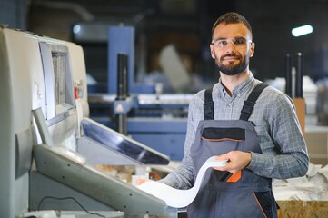 Man working in printing house with paper and paints