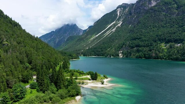 View to Julian Alps mountains above Predil lake in Italy with small lake. Predil Lake, Friuli Italy / (Lago del Predil), beautiful alpine lake in north Italy near the Slovenian border, Italy.