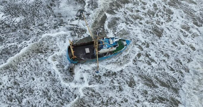 Stuck shrimp trawler IJmuiden 22 'Black Jack' in front of the coast of Zandvoort, The Netherlands.