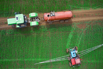 Chemical protection of seedlings from diseases and pests. Tractor with a tank with pesticide...