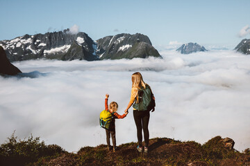 Family traveling in mountains mother and daughter hiking together in Norway, adventure trip outdoor...