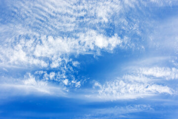 White altocumulus clouds pattern in blue sky on a sunny day, natural background photo