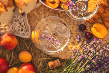 Obraz na płótnie Canvas Picnic with wine in a lavender field. Selective focus.