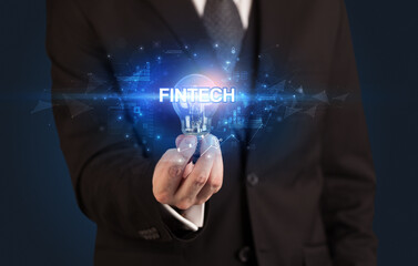 Businessman holding a light bulb