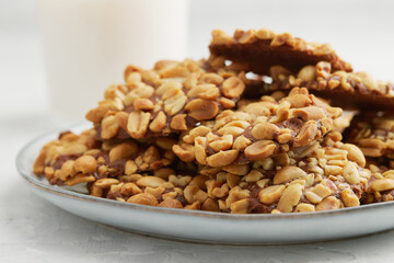 A heap of Portugues traditional peanut cookies known as Bolachas de Amendoim on the grey plate