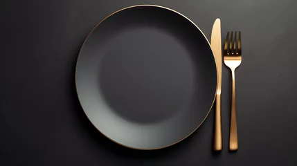 Foto op Plexiglas Dark plate with with golden cutlery on black background © Oksana