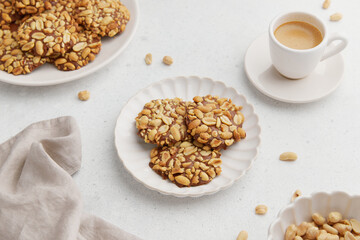 A heap of Portugues traditional peanut cookies known as Bolachas de Amendoim on the white plate