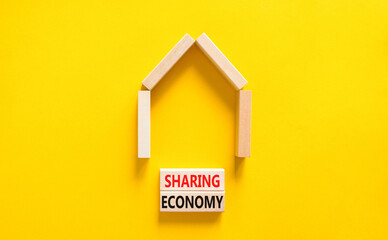 Fototapeta na wymiar Sharing economy symbol. Concept words Sharing economy on beautiful wooden blocks. Beautiful yellow table yellow background. House model. Business sharing economy concept. Copy space.