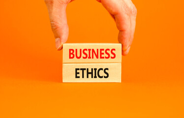 Business ethics symbol. Concept words Business ethics on beautiful wooden blocks. Beautiful orange...