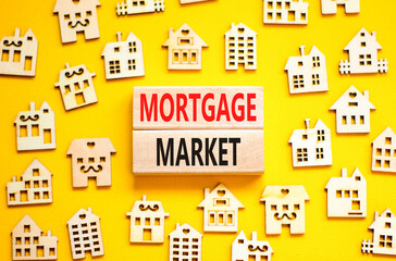 Mortgage market symbol. Concept words Mortgage market on beautiful wooden blocks. Beautiful yellow table yellow background. House model. Business mortgage market concept. Copy space.