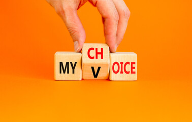 My voice choice symbol. Businessman turns wooden cubes and changes the concept word My choice to My...