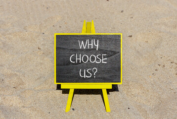Why choose us symbol. Concept word Why choose us on beautiful wooden black chalk blackboard. Sand beach. Beautiful sand beach background. Business motivational why choose us concept. Copy space.