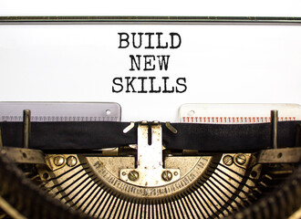 Build new skills symbol. Concept word Build new skills typed on beautiful retro old typewriter. Beautiful white paper background. Business, education build new skills concept. Copy space.