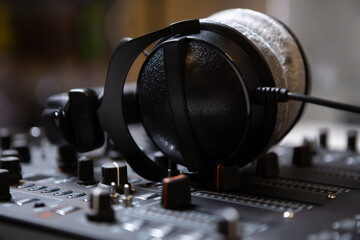 Professional DJ earphones on audio mixer. Audio equipment for disc jockey to play music