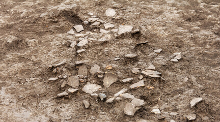Archaeological excavations, archaeologists work, dig up an ancient clay artifact which is five...