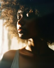 Confident young african american woman with curly hair in a casual fashion portrait