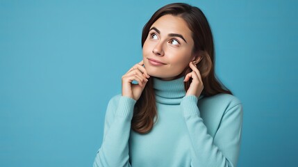 Youthful english lady disconnected on blue background thinking