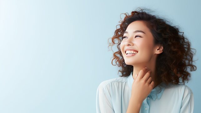A picture of a young woman smiling as she thinks about something
