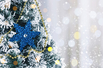 Christmas card with a blue star on a Christmas tree, Christmas decorations on a snowy background.