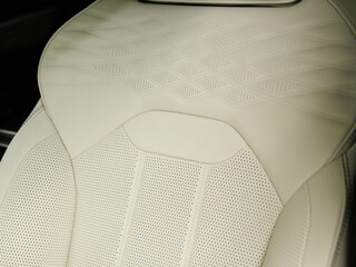 Beige luxury modern car Interior. Detail of modern car interior. Part of perforated leather seats...