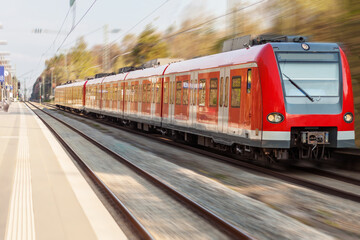 Electric Train on Railway Station. Passenger High Speed Red Train with Motion blur in Station Platform.