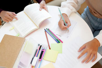 Two college students study and prepare for the exam on the table.