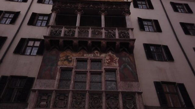 Innsbruck, Austria, December 7, 2022: TILT SHOT - The Goldenes Dachl (Golden Roof), ornamented with 2,738 fire-gilded copper tiles, in the Old Town (Altstadt) section of Innsbruck. 