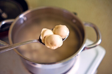Undercooked dumplings on a spoon