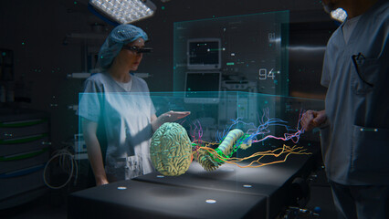 Medical professionals in AR headsets work in operating room using holographic display. 3D graphics...